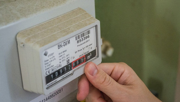 UK home owner examining average electricity usage on meter
