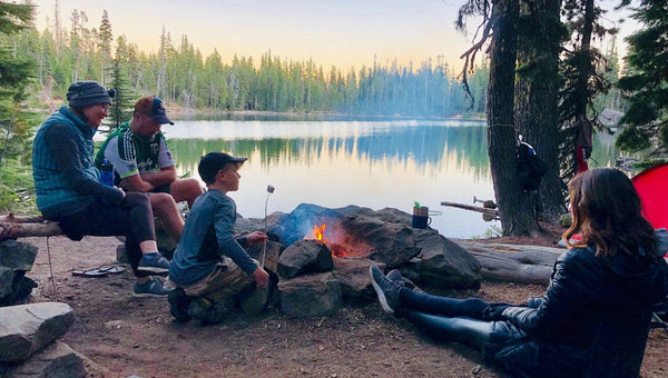 family camping around lake