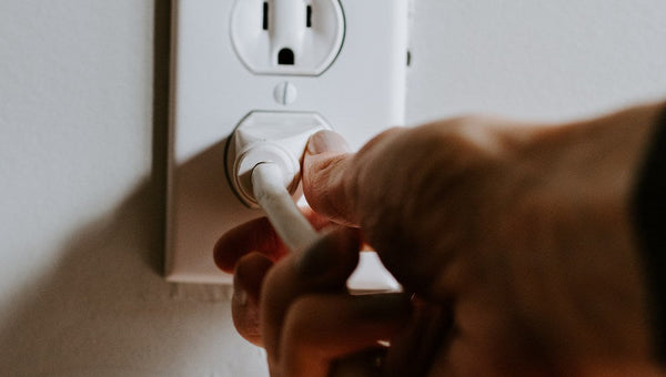 plugs cord into wall using dual fuel generator as main power source