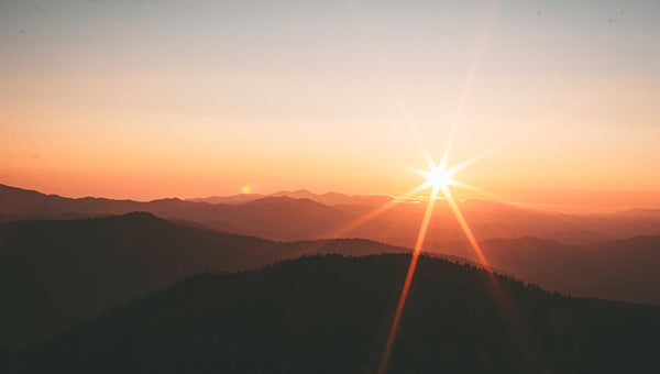 sunrise over hill powering portable solar generator