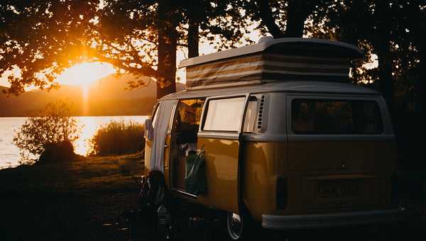 yellow camper van with essentials parked up watching sunset