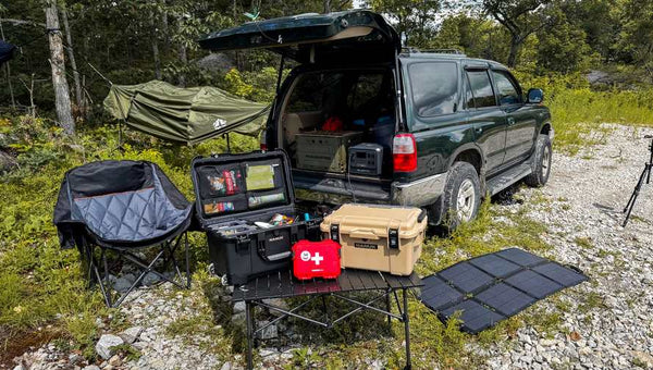 Off-road campsite with organized gear and portable solar panels